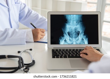 doctor diagnose pelvis hipbone lumber vertebrae spine x-ray image  for diagnose Herniated disc disease with radiologic technologist team.
 - Powered by Shutterstock