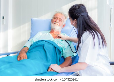 The Doctor Is Diagnosing The Patient On The Bed Of Hospital.