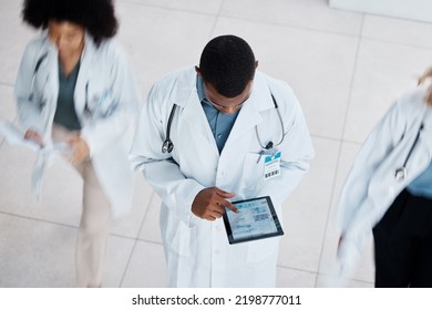 Doctor, Digital Tablet Test And Medical Worker With Research Lab Data On Technology In Busy Hospital From Above. Healthcare Man, Working People And Insurance Employee In Medicine Wellness Health Room