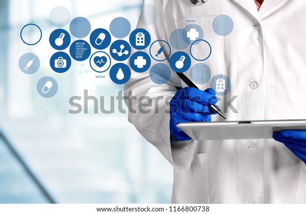 Doctor with\
digital tablet and variety medical\
icons