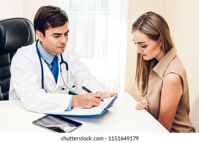 Doctor discussing and consulting with female patien on doctors table in hospital.healthcare and medicine