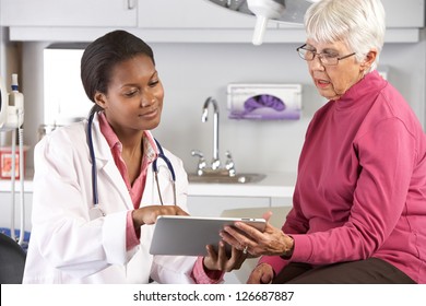 Doctor Discussing Records With Senior Female Patient - Powered by Shutterstock