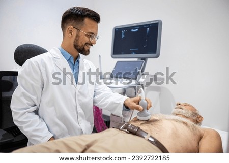 Doctor doing abdominal ultrasound checking the patient digestion system.