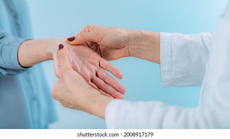 Doctor Doing Carpal Tunnel Syndrome Test With A Senior Woman.