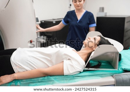 Doctor doing computed tomography for female patient stock photo. Medicine diagnostic concept