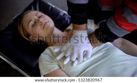 Doctor doing CPR to woman, patient death, mortality from road traffic accidents