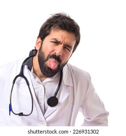 Doctor doing a joke over isolated white background
