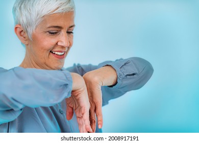 Doctor Doing Medical Exam With Senior Woman, Checking For Carpal Tunnel Syndrome.