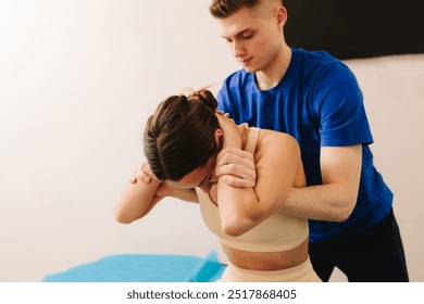 Doctor is doing physical manipulation to female client to increase joints mobility. Osteopathy to heal back and shoulder injury. Doing physiotherapy to overcome physical trauma - Powered by Shutterstock