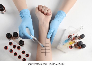 Doctor doing skin allergy test at light table, top view - Powered by Shutterstock