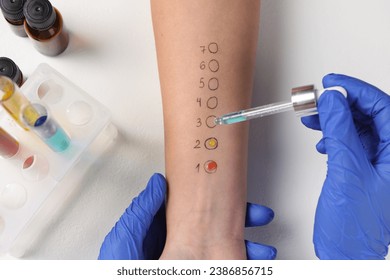 Doctor doing skin allergy test at light table, top view - Powered by Shutterstock