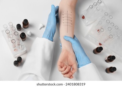 Doctor doing skin allergy test at light table, top view - Powered by Shutterstock