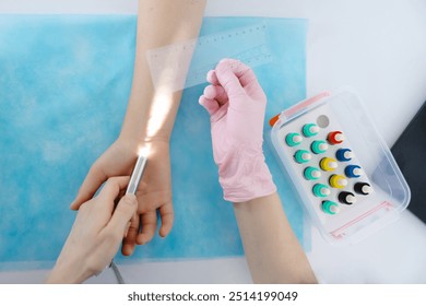 Doctor doing skin allergy test at white table in office. Immunology doctor is measuring allergy reaction of patient. - Powered by Shutterstock