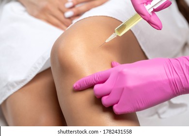 Doctor Doing Stem Cell Therapy On A Patient's Knee After The Injury. Treating Knee Pain With Platelet-rich Plasma Injection. Treatment Of Arthritis And Osteoarthritis.Medical And Cosmetology Concept. 