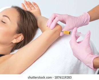 Doctor Doing Stem Cell Therapy On A Patient's Elbow After The Injury. Treating Knee Pain With Platelet-rich Plasma Injection. Treatment Of Arthritis And Osteoarthritis.Medical And Cosmetology Concept.