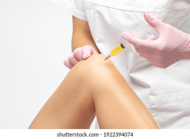 Doctor Doing Stem Cell Therapy On A Patient's Knee After The Injury. Treating Knee Pain With Platelet-rich Plasma Injection. Treatment Of Arthritis And Osteoarthritis.Medical And Cosmetology Concept.