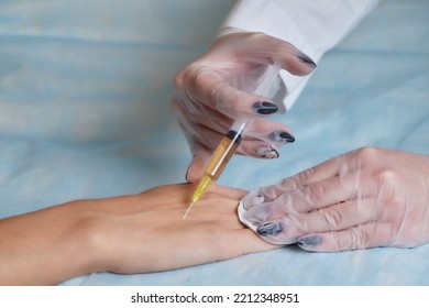 Doctor Doing Stem Cell Therapy On A Patient's Elbow After The Injury. Treating Knee Pain With Platelet-rich Plasma Injection. Treatment Of Arthritis And Osteoarthritis.Medical And Cosmetology Concept.