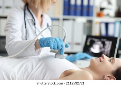 Doctor doing ultrasound examination of breast of patient in clinic - Shutterstock ID 2112532721