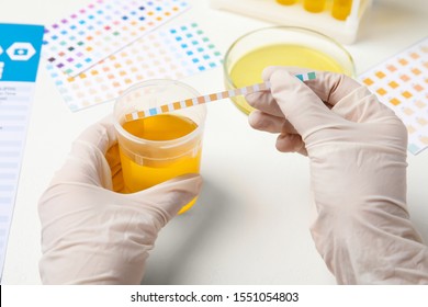Doctor doing urine analysis at white table