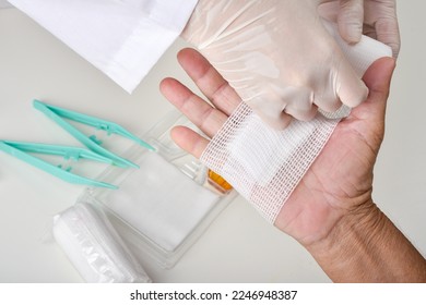 Doctor doing wound dressing care and bandaging patient's hand, Hand surgery treatment, Nurse treat patient's finger injury in hospital. - Powered by Shutterstock