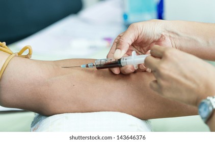 Doctor Drawing Blood Sample From Arm For Blood Test