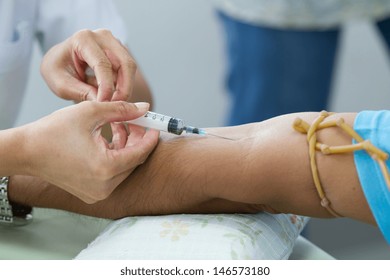 Doctor Drawing Blood Sample From Arm For Blood Test 