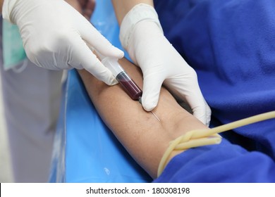 Doctor Drawing Blood Sample From Arm For Blood Test 