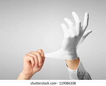 Doctor Dress Gloves On Hands On Gray Background