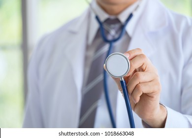 Doctor in a dressing gown with a stethoscope examination in the hands