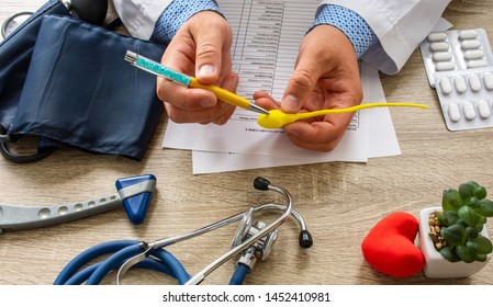 Doctor during consultation held in his hand and shows patient anatomical model of male sperm. Counseling of men and couples about male infertility, sperm pathology, impossibility to get pregnant