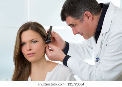 Doctor ENT Checking Ear With Otoscope To Woman Patient At Hospital