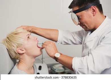 Doctor ENT Checking Ear With Otoscope To Woman Patient