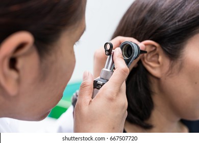 Doctor examined the patient's ear with Otoscope. Patient seem to have problems with hearing. - Shutterstock ID 667507720