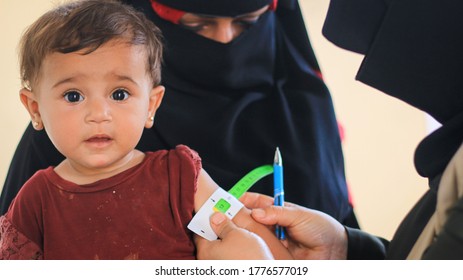 A Doctor Examines Child Malnutrition