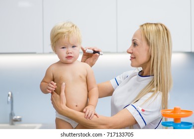 the doctor examines the child's ear - Powered by Shutterstock