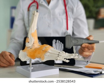 Doctor examines foot model using ultrasound. X-ray of ankle and foot pain and rheumatism treatment - Powered by Shutterstock