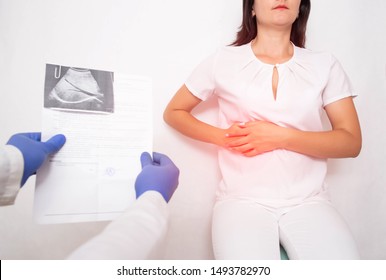 The doctor examines a girl patient with pain in the hypochondrium gall bladder. Gallbladder disease cholecystitis and biliary dyskinesia - Shutterstock ID 1493782970