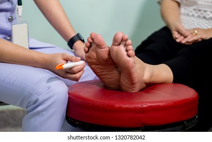 The doctor examines the nerve response with monofilament odiatrist treating feet during procedure. Doctor neurologist examining female patient .