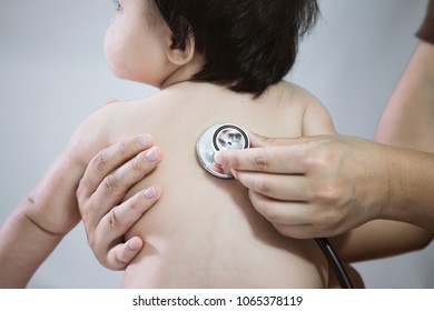 Doctor examining asian baby girl and listen her heart beat with stethoscope in the hospital - Shutterstock ID 1065378119