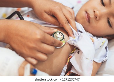 Doctor Examining Asian Child Girl And Listen Her Lung And Heart Sound With Stethoscope In The Hospital