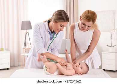 Doctor Examining Baby With Stethoscope At Home