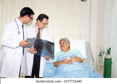 Doctor Examining Chest X-ray Film  Which Doctor Holding X-ray, X-ray Film Of Older Woman Patient At Hospital