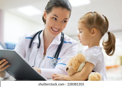 doctor examining a child in a hospital - Powered by Shutterstock