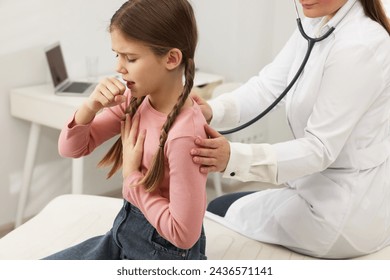 Doctor examining coughing girl in hospital. Cold symptoms - Powered by Shutterstock