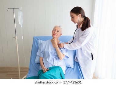 doctor examining an elderly woman patient at hospital room - Shutterstock ID 1774423631