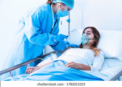 Doctor examining female patient in critical health conditions using a stethoscope in the intensive care unit of a modern hospital during covid-19 pandemic - Shutterstock ID 1782015323