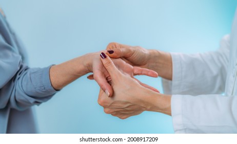 Doctor Examining Hand Of Senior Patient With Pain In Wrist. Carpal Tunnel Syndrome.