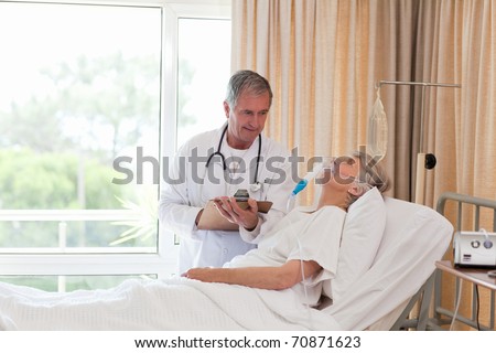 Similar – Female doctor filling questionnaire to senior patient