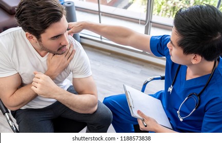 Doctor Examining Injured Shoulder Of Young Athlete Patient In Clinic, Sports Medicine Concept