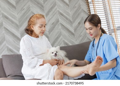 Doctor Examining The Knee Asian Senior Old Woman Patient Suffering From Pain In Knee On Bed In Medical Office Room At Hospital. Patient At The Physiotherapy Doing Physical Exercises With His Therapist